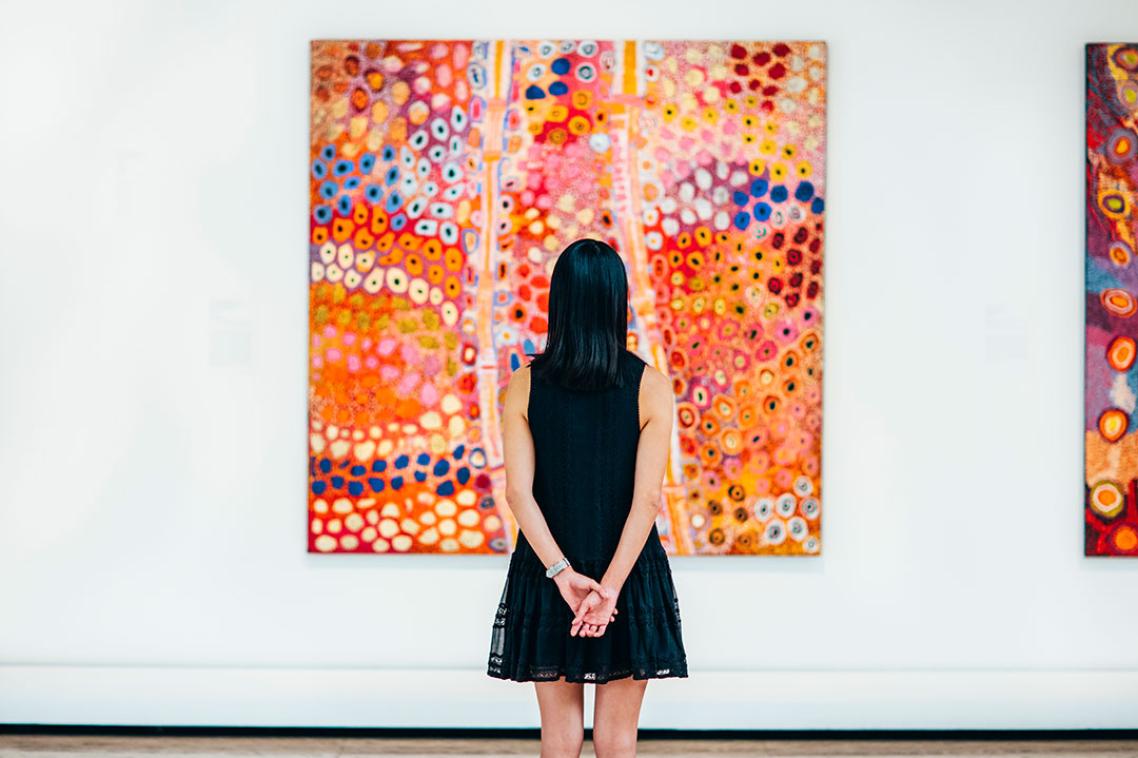 A patron at Queensland Art Gallery, appreciating a painting.