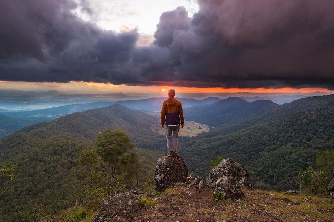 A hiker looking out from Lukes Bluff over the Scenic Rim, south of Brisbane.
