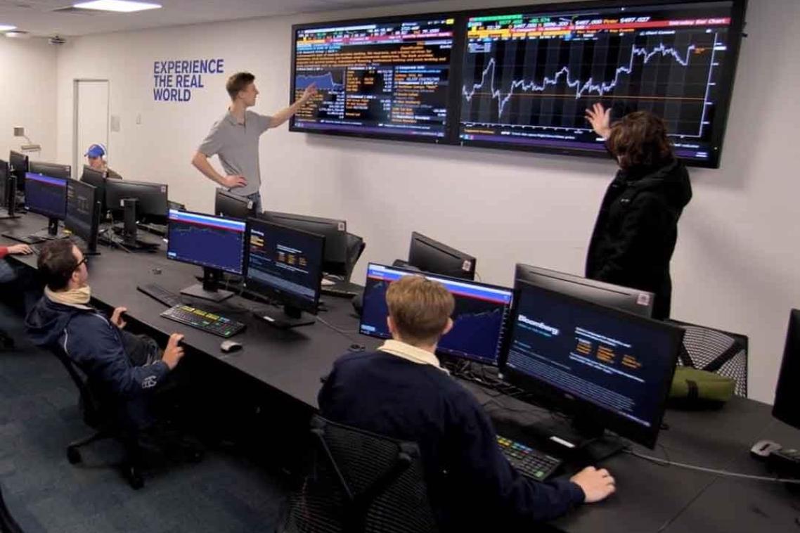 Students look at a trading chart in the Bloomberg Trading Lab