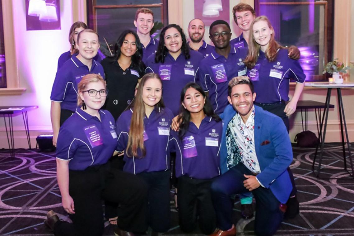 Students that are part of the Young Achievers Program wearing UQ shirts at an event.