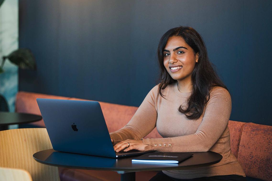 Bachelor of Commerce student working on a laptop.