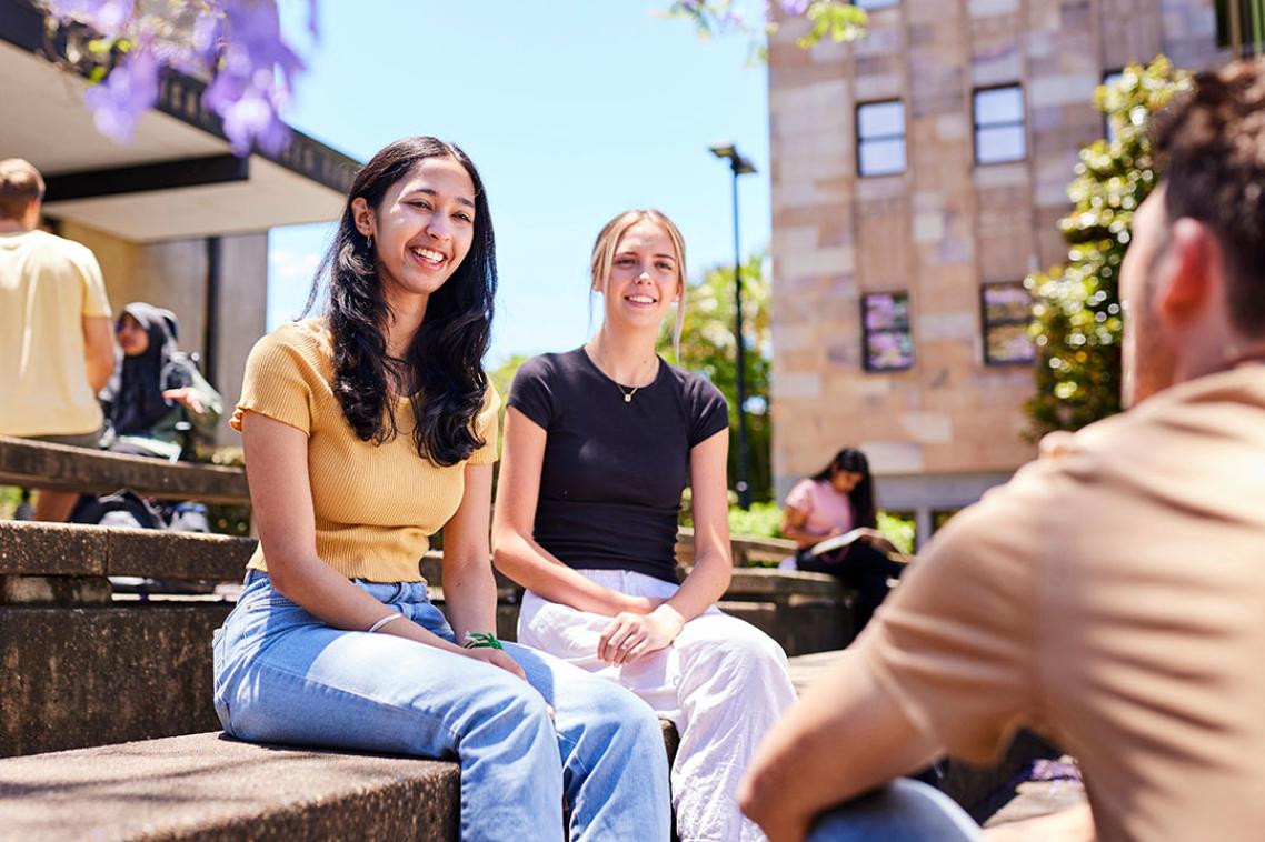 Students sitting in sunny courtyard