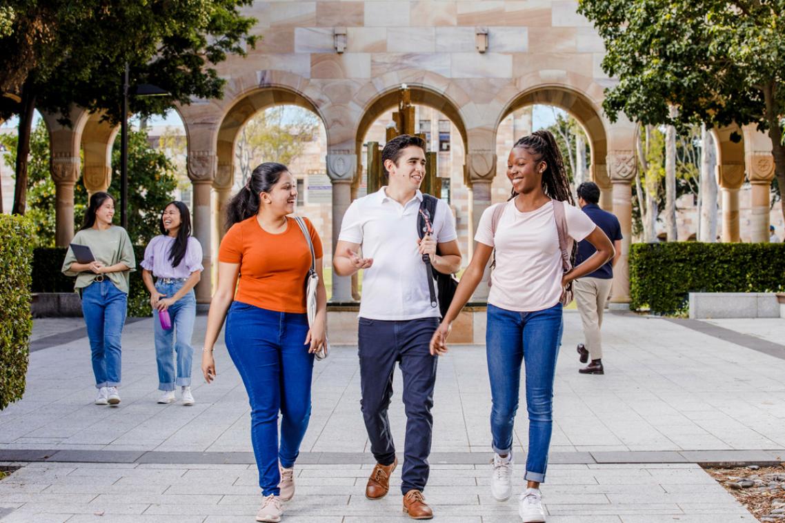 Group of international students walking through the Great Court of The University of Queensland's St Lucia campus.