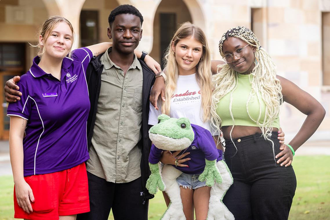 4 young achievers with arms around each other in the Great Court